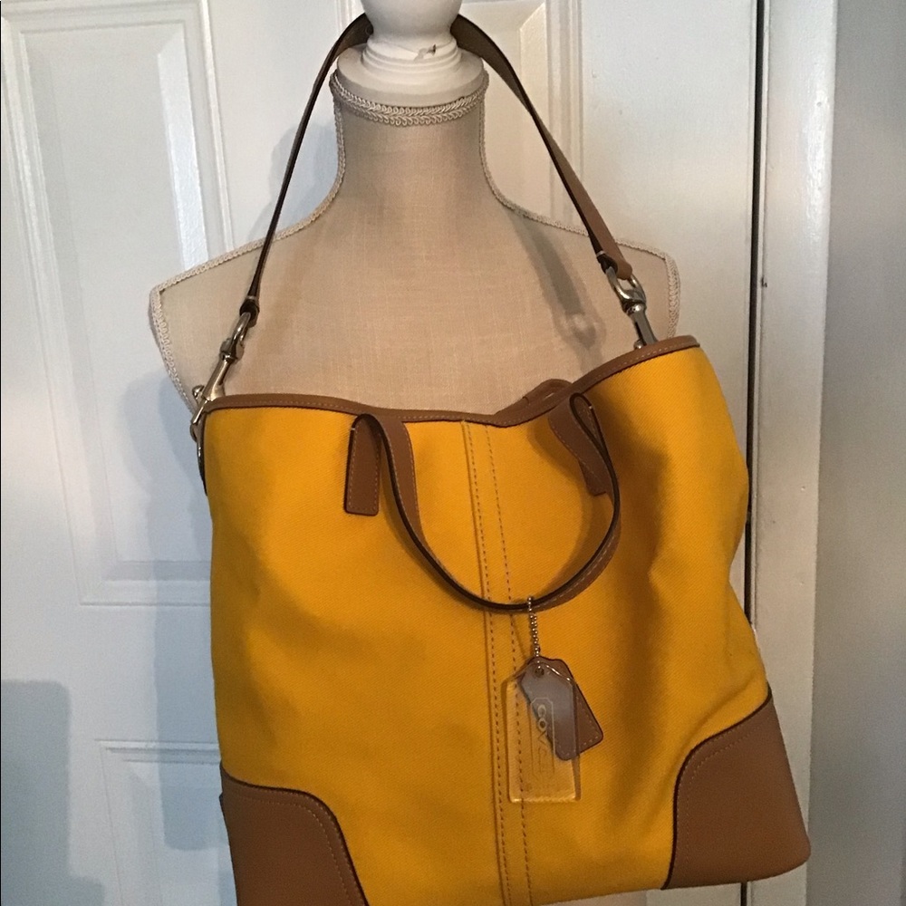 Like new Coach tote bag, beautiful deep yellow color with brown leather.